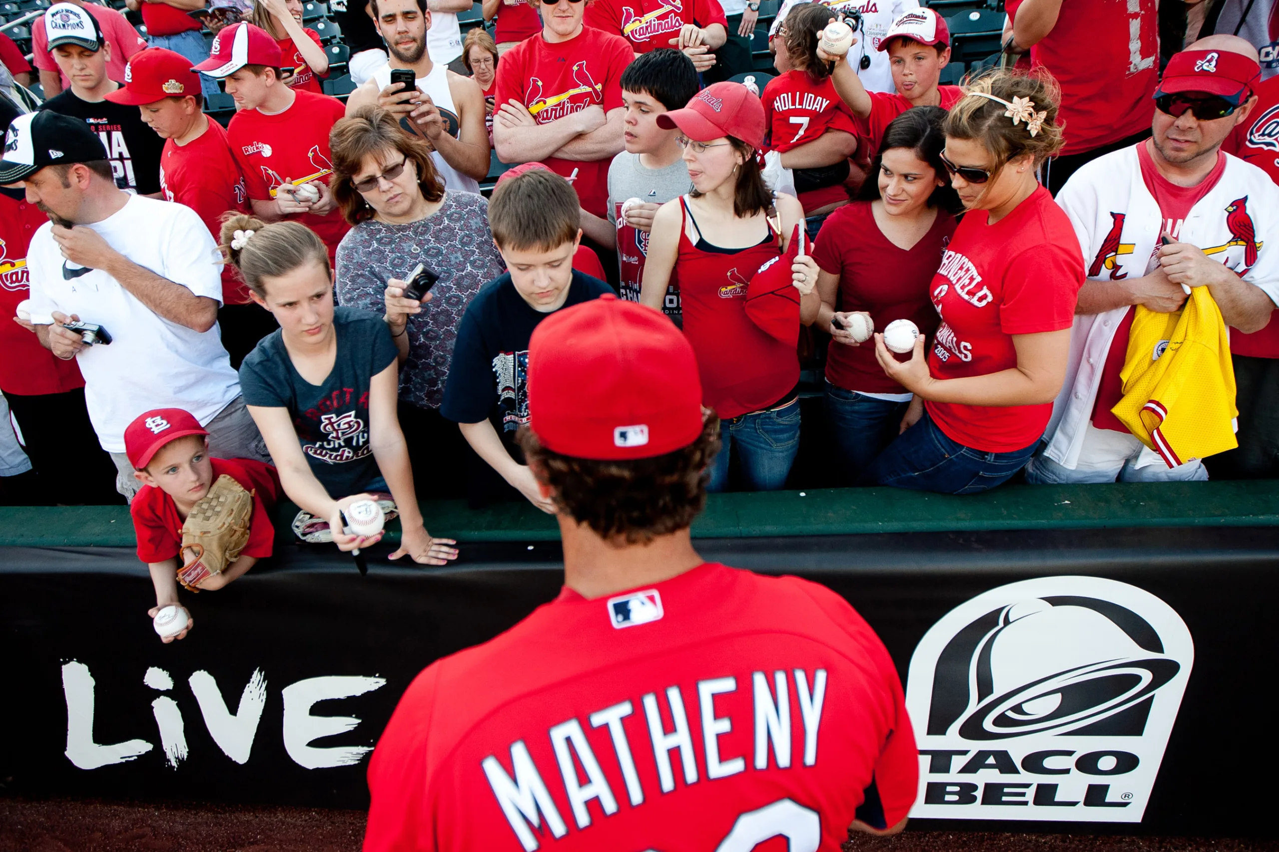 Head Coach Mike Matheny (22) of the St. Louis Cardinals signs autographs for fans prior to a game against the Springfield Cardinals at Hammons Field on April 2, 2012 in Springfield, Missouri.
