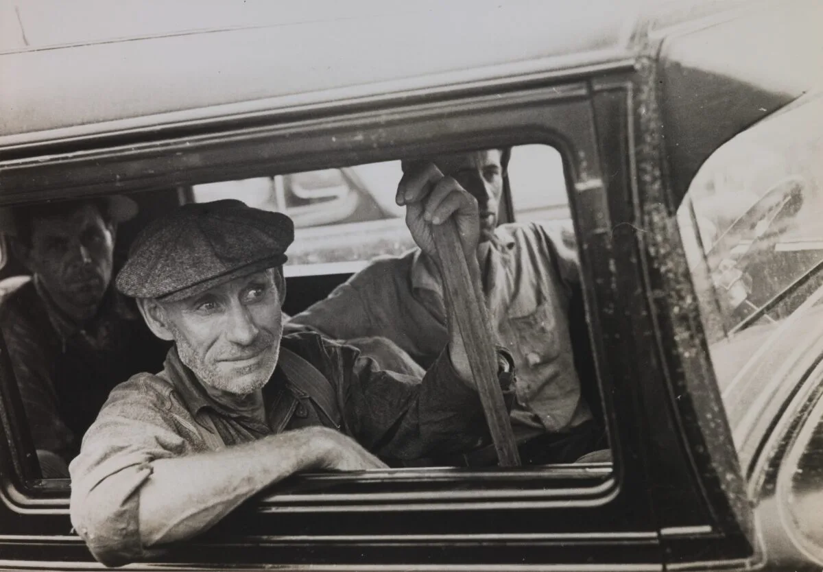 Russell Lee's c. 1936 image of three men looking out of a truck.