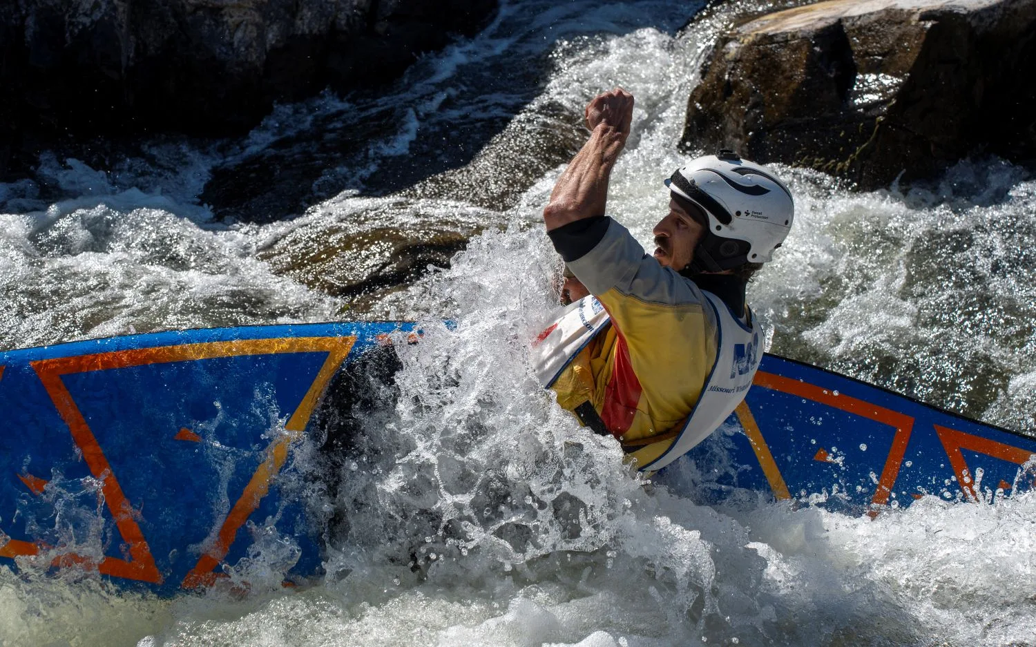 Man paddling in a kayak on the whitewater of the St. Francis River