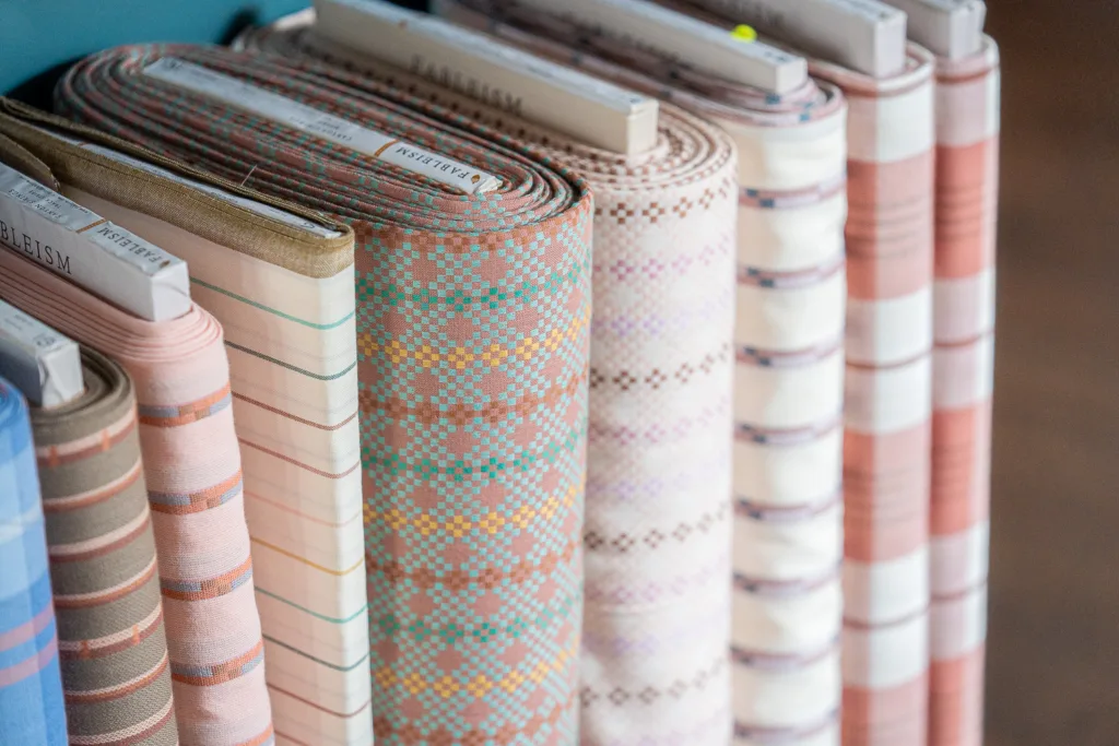 a collection of striped fabrics in a multitude of soft hues