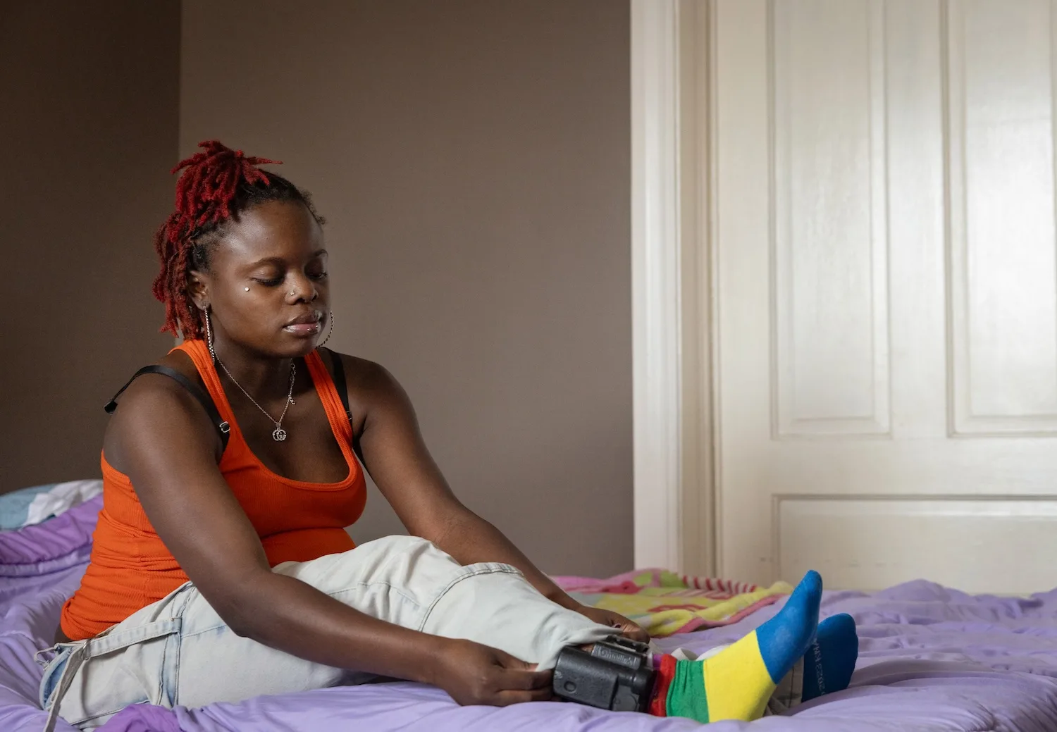 Khyla Mason examines her ankle monitor.