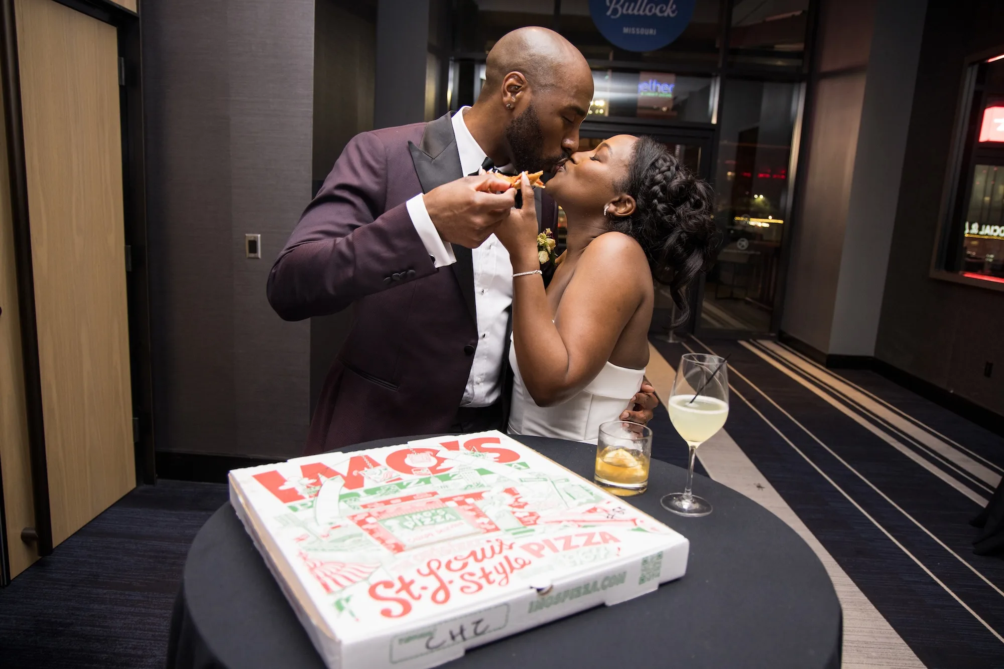 Lauren and Marcus Lee eat Imo's Pizza on their wedding night.