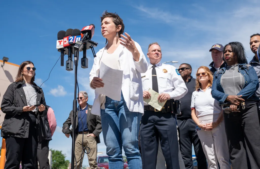 Cara Spencer in front of microphones