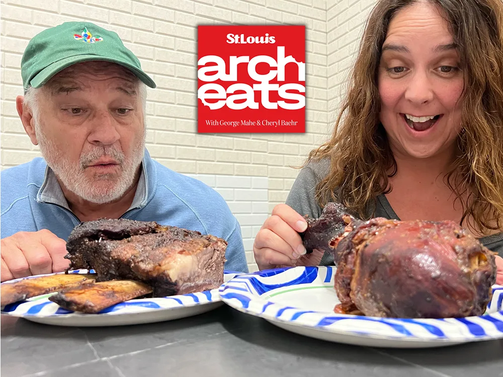 Arch Eats hosts George Mahe and Cheryl Baehr with plates of BBQ
