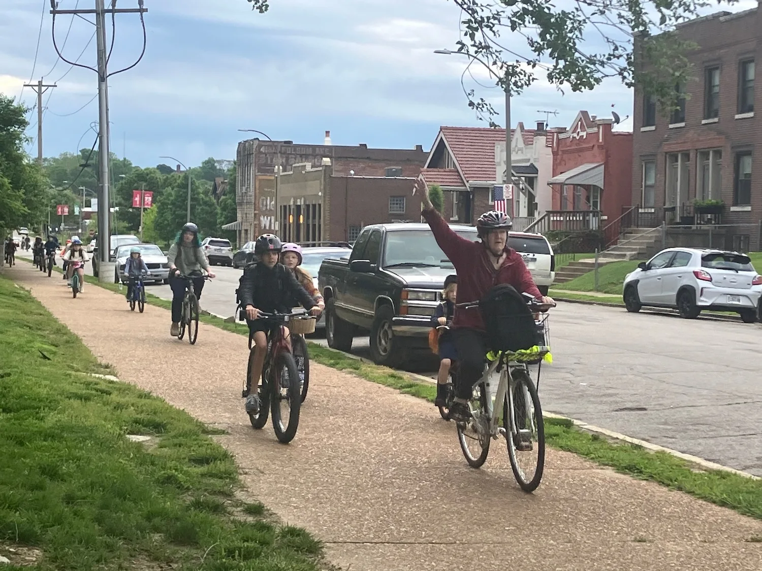Students in a "bike bus" ride the sidewalk up to City Garden Montessori.