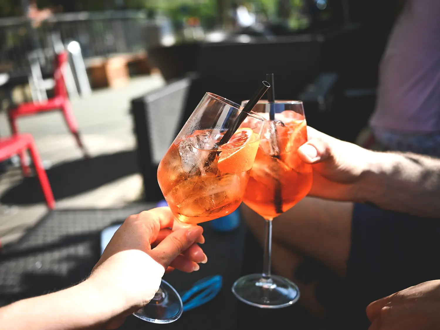 People celebrating with spritz cocktails in wineglasses
