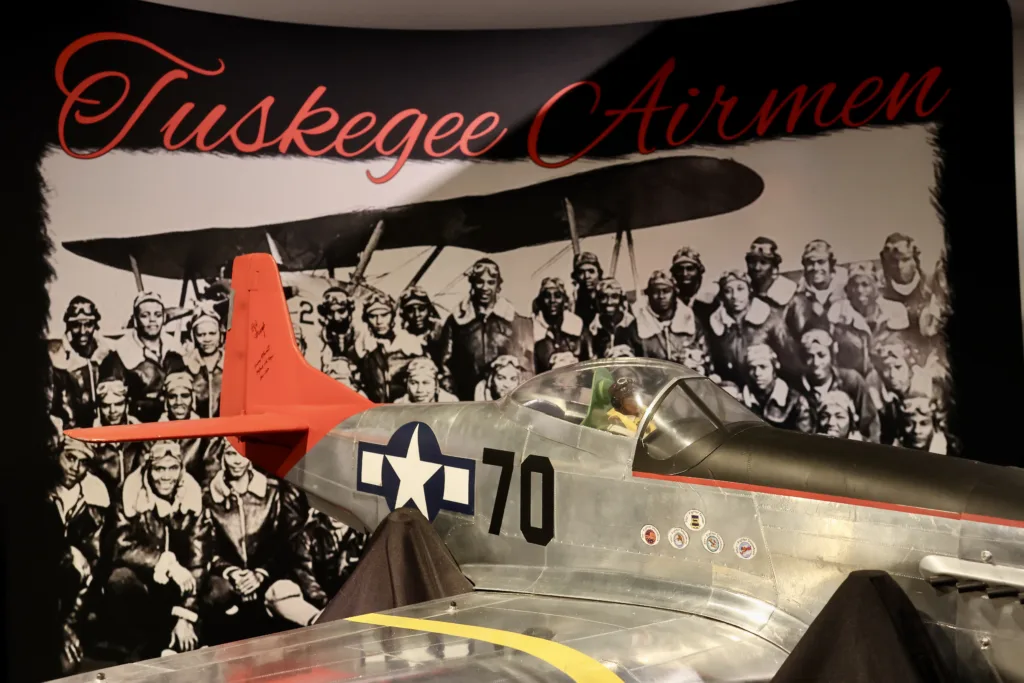 A replica P-51 Mustang aircraft created by Bill Hence sits in the Tuskegee Airmen exhibit at Soldiers Memorial.