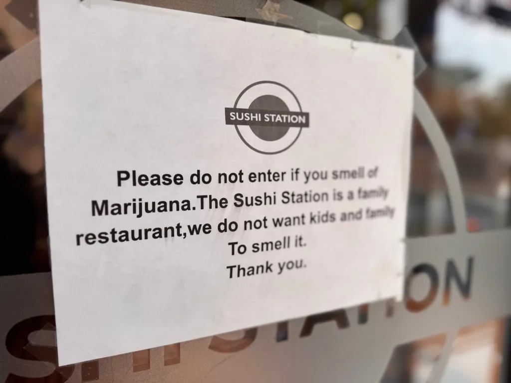 The sign taped to Sushi Station.