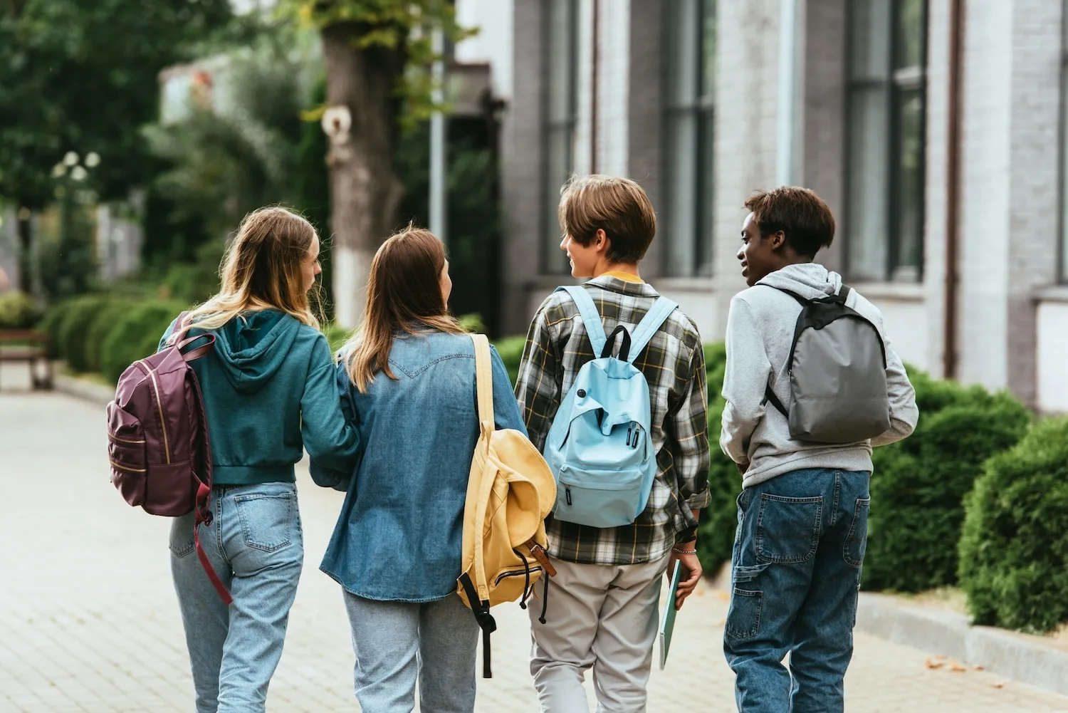 Teenage students with backpacks.
