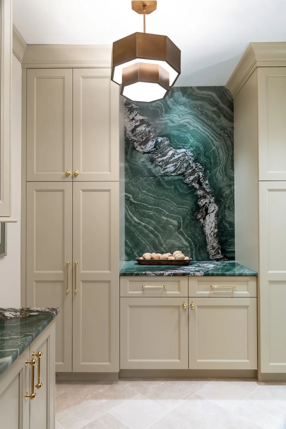 The kitchen hall features lighting that softly illuminates stone accents