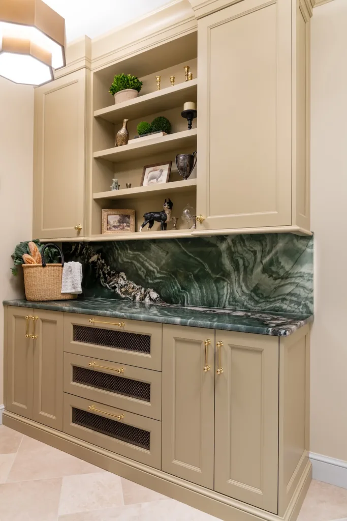 The kitchen hall features lighting that softly illuminates stone accents