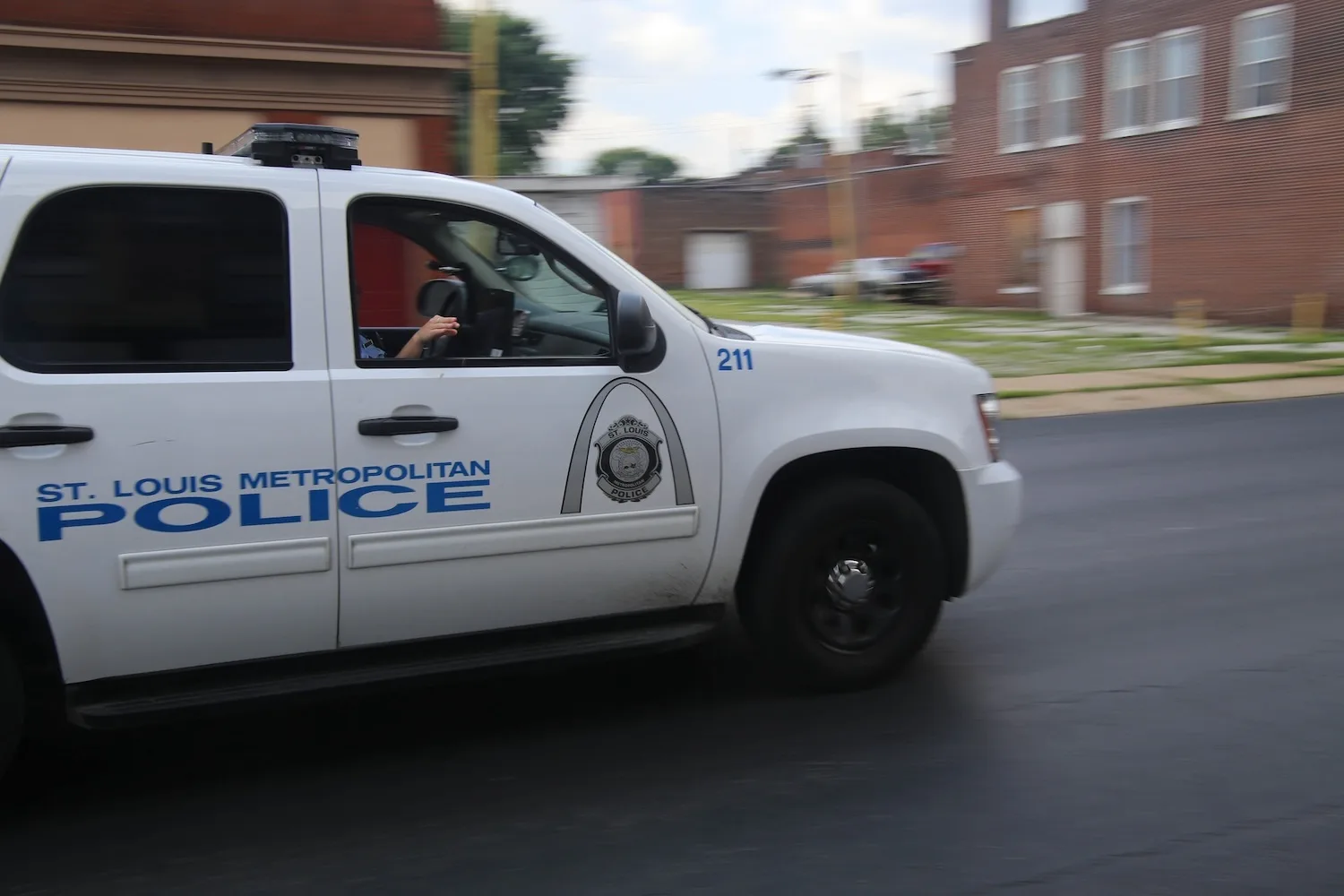A St. Louis Metropolitan Police Department SUV drives down a city street.
