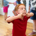 Child sticking tongue out at Ice Cream social
