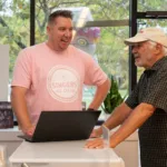 Man wearing Singers ice cream shirt talking to George at the Ice Cream Social