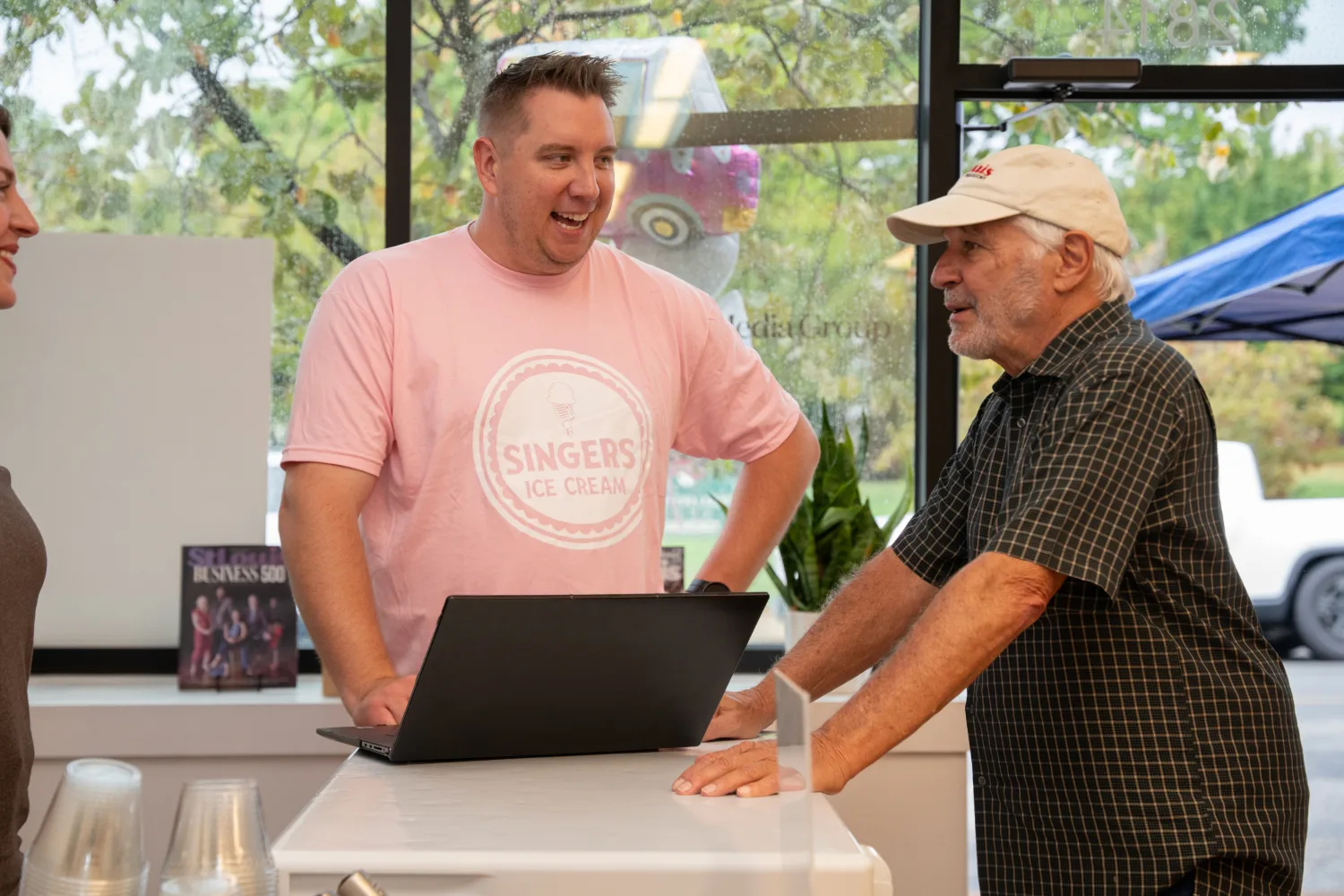 Man wearing Singers ice cream shirt talking to George at the Ice Cream Social