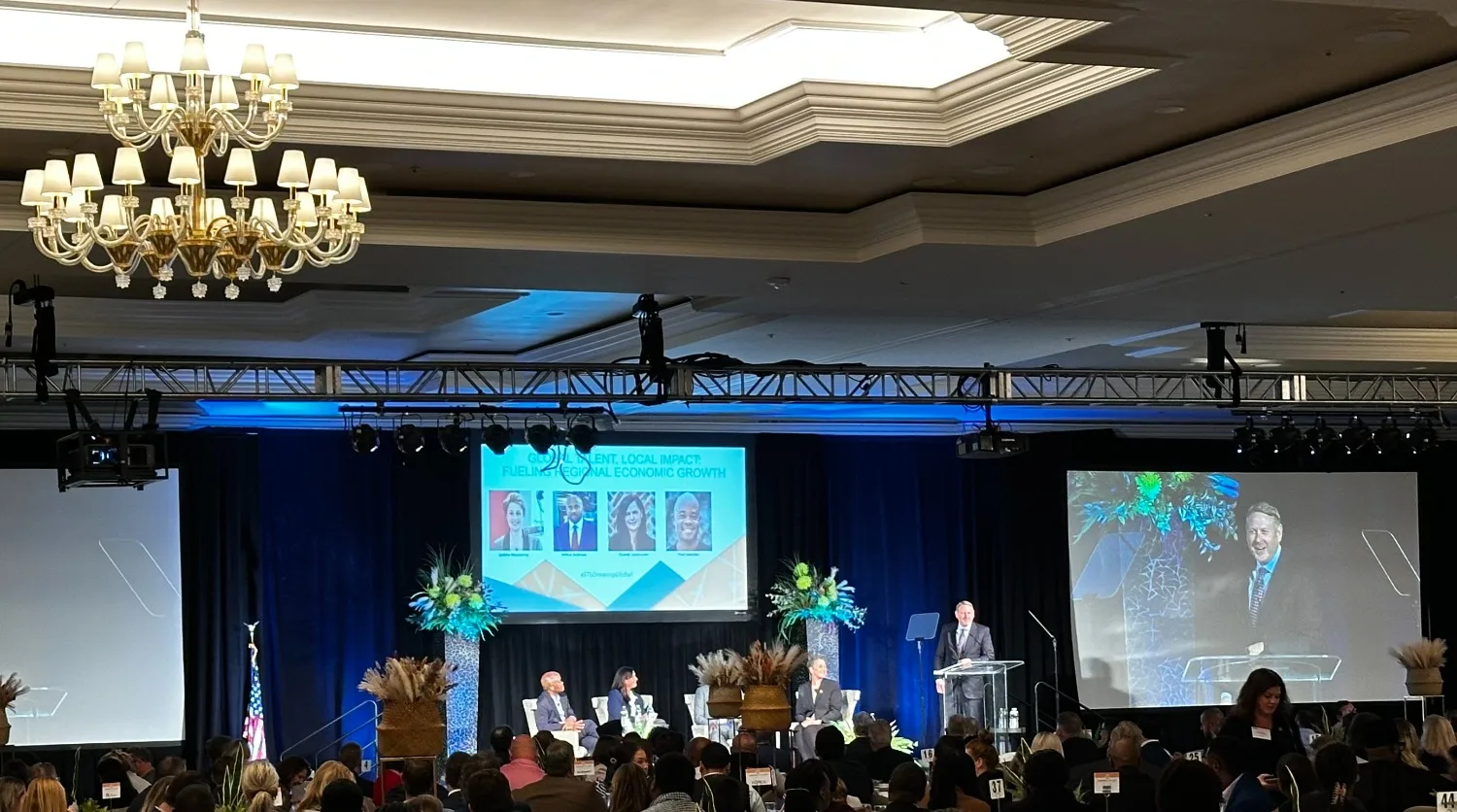 World Trade Center St. Louis executive director Tim Nowak speaks on stage.