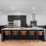 Campbell House and Home kitchen featuring black cabinetry, open shelving, fusing natural materials with modern design.