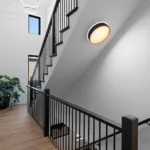 Custom open staircase with black steel railing and modern light fixtures designed by Campbell House and Home.