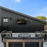 Rooftop deck designed by Campbell House and Home with modern seating and string lights.