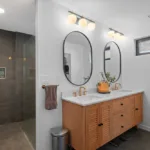Contemporary bathroom by Campbell House and Home with double vanity and walk-in shower.