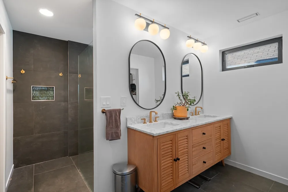 Contemporary bathroom by Campbell House and Home with double vanity and walk-in shower.