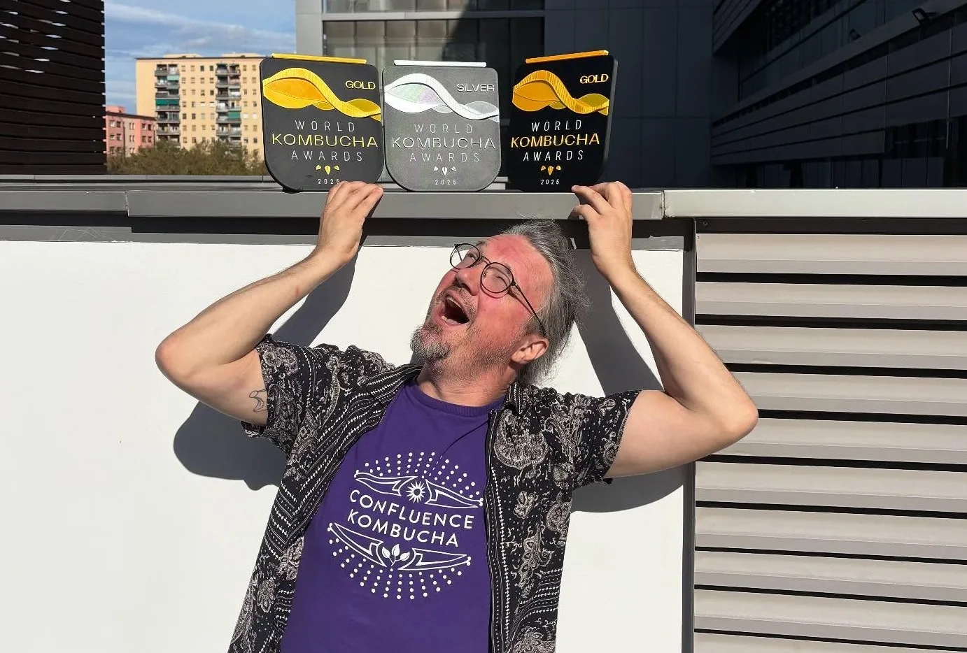 Confluence Kombucha's William Esslinger poses with the South City fermentory's three trophies at the World Kombucha Awards in Barcelona.