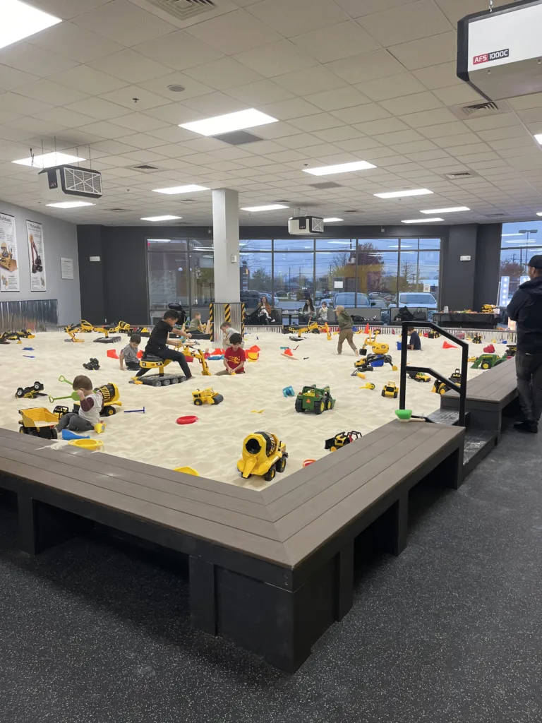 The main feature of Little Diggers play spaces is a large, indoor sandbox.