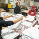 Workers laying out white towels
