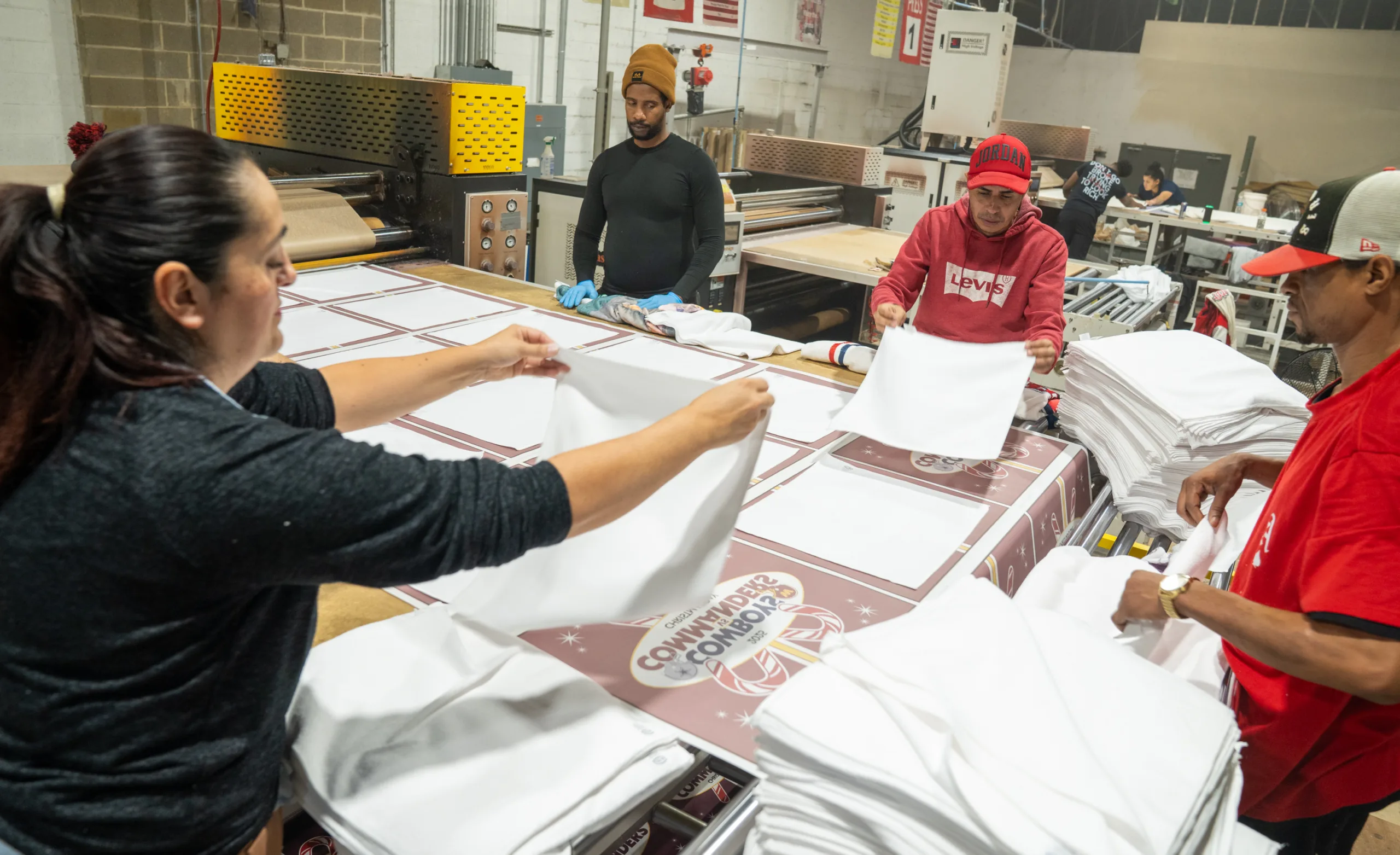 Workers laying out white towels