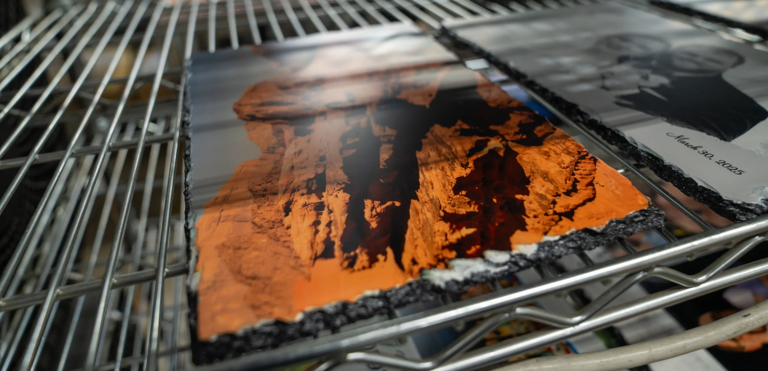A piece of black slate with a photo on it.