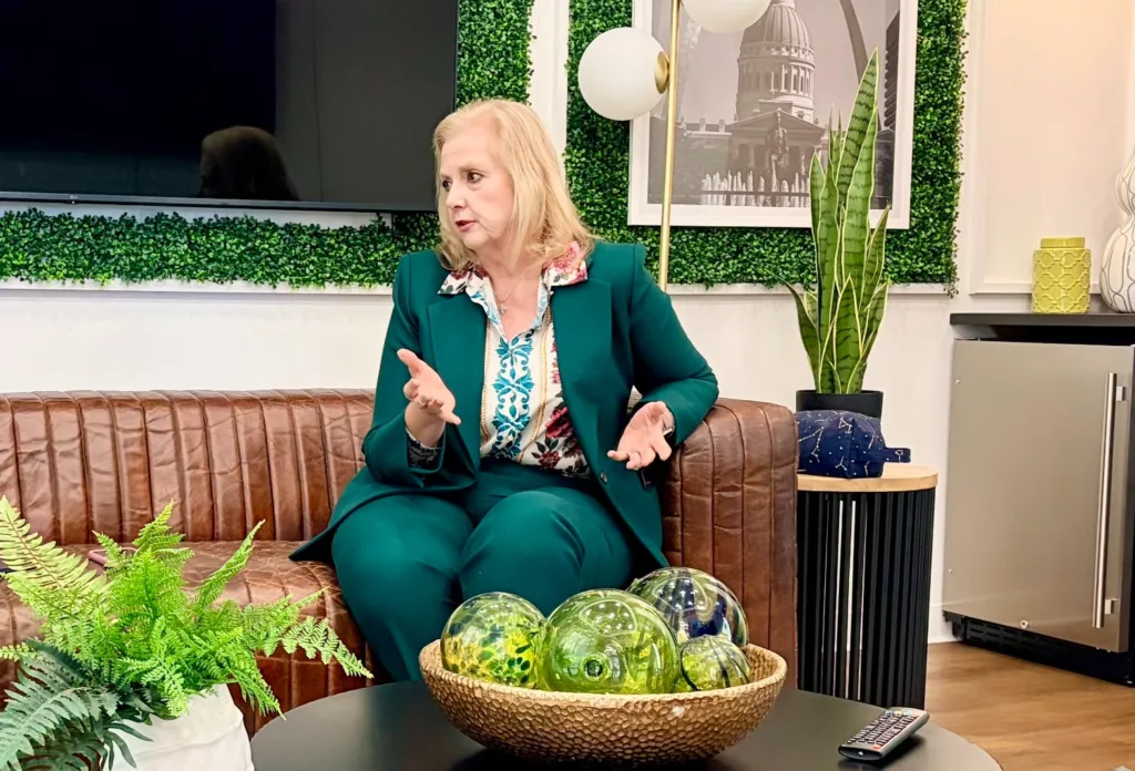A woman sits on a couch.