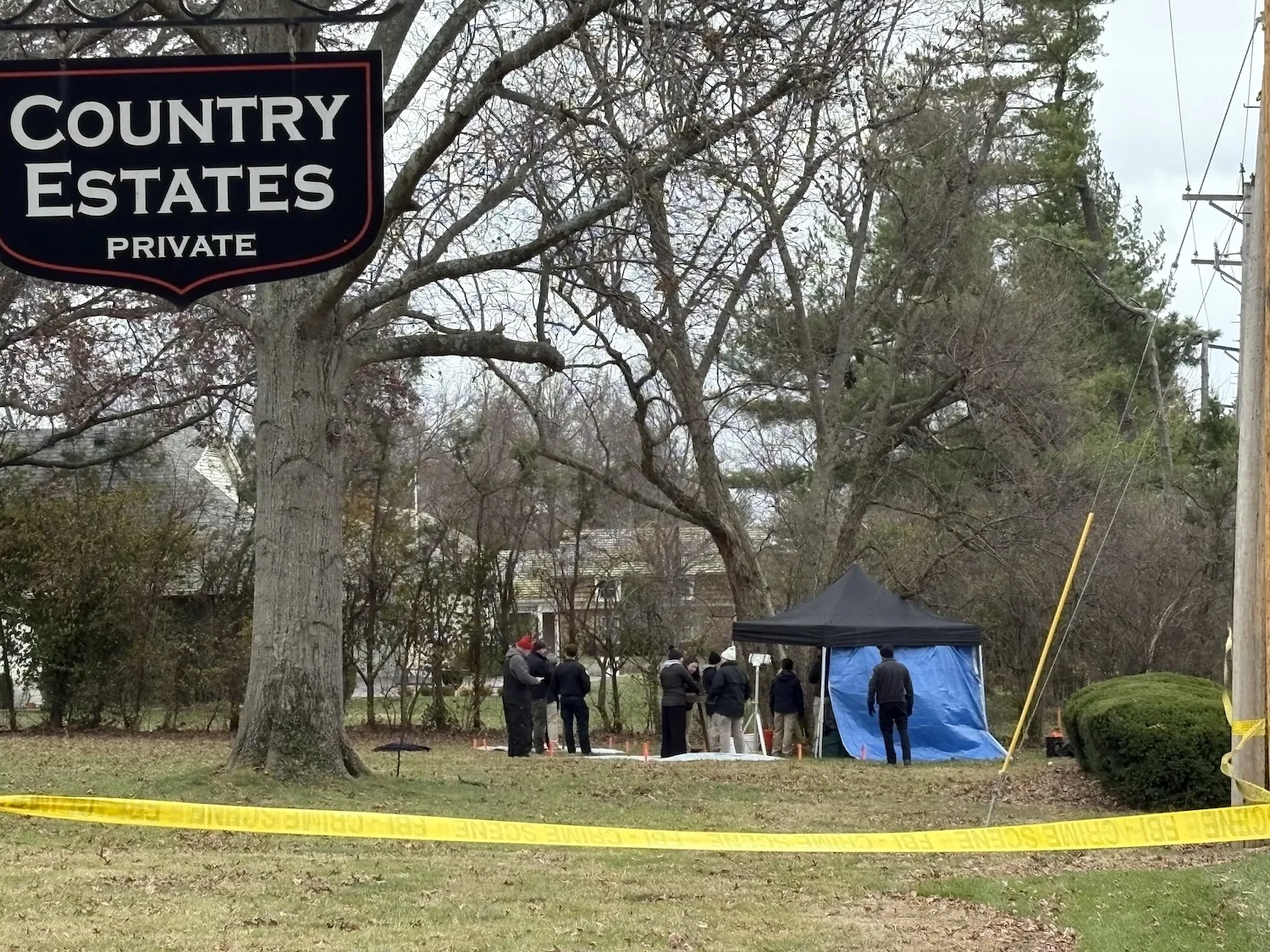 Law enforcement digs up a lawn in Frontenac.
