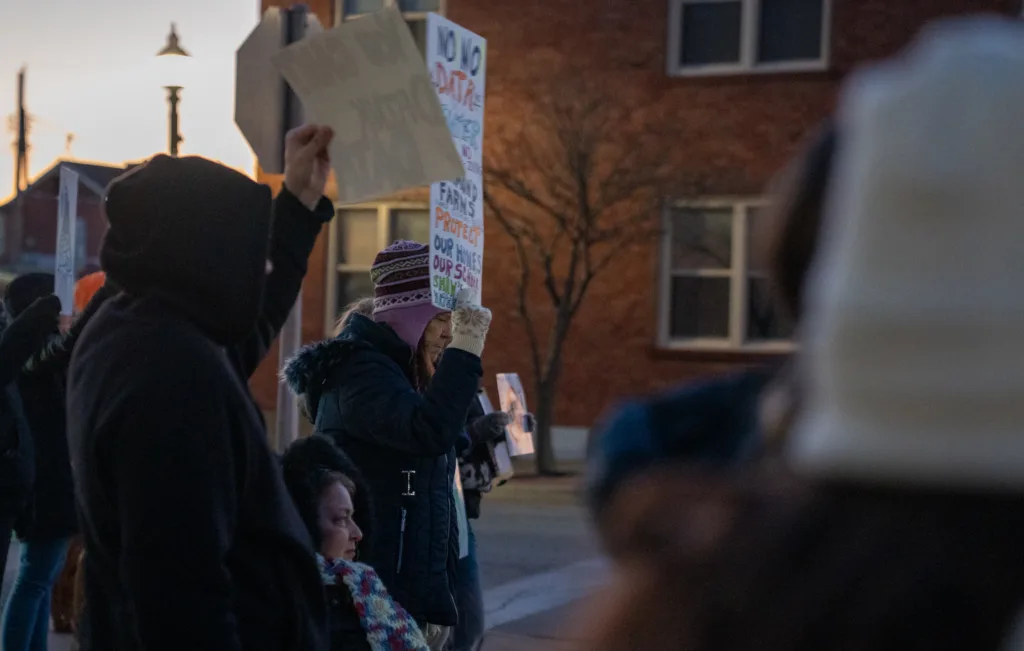 A woman holding a sign.