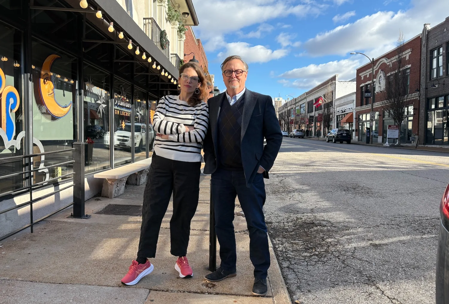 Two people stand on Locust Street.