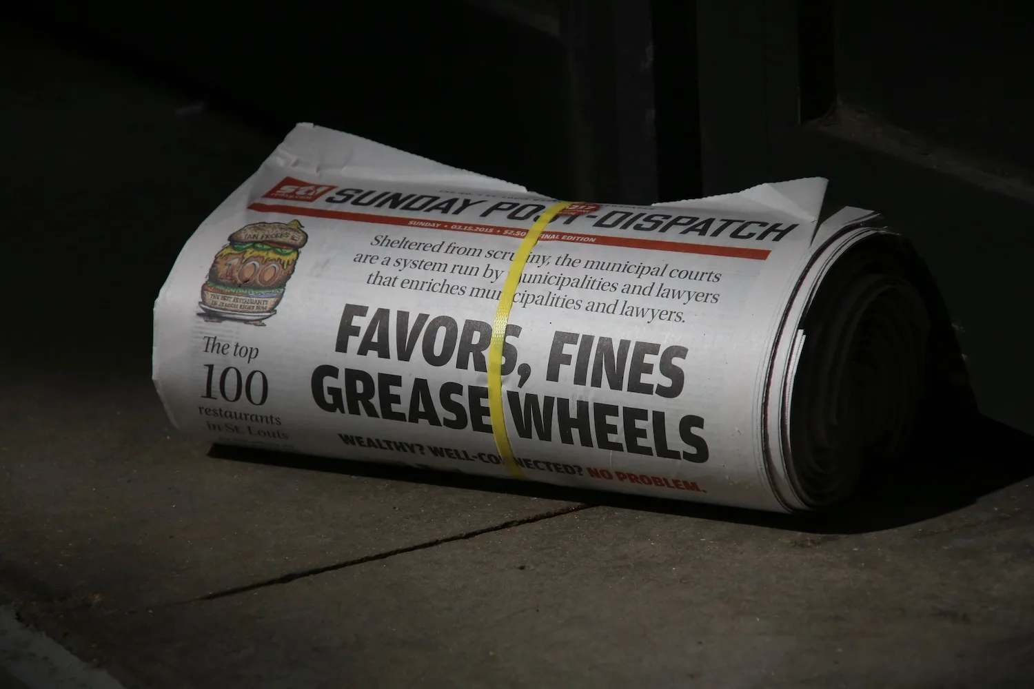 A rolled-up St. Louis Post-Dispatch.