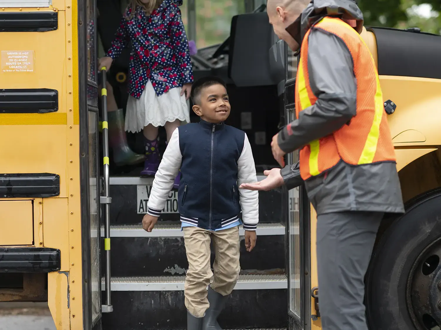 A student gets off a school bus.