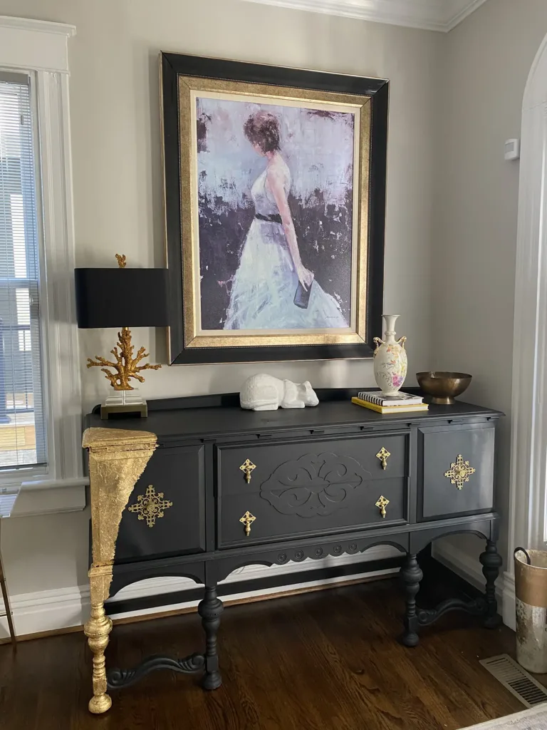 A unique entry table painted with gold leaf appears in a foyer designed by Joni Spear.