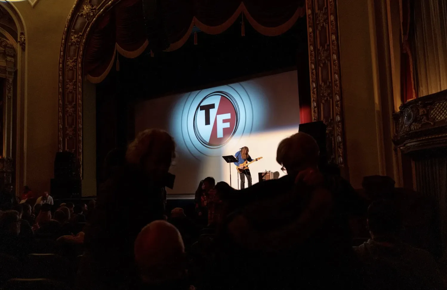 A busker performs before a screening at True/False 2025