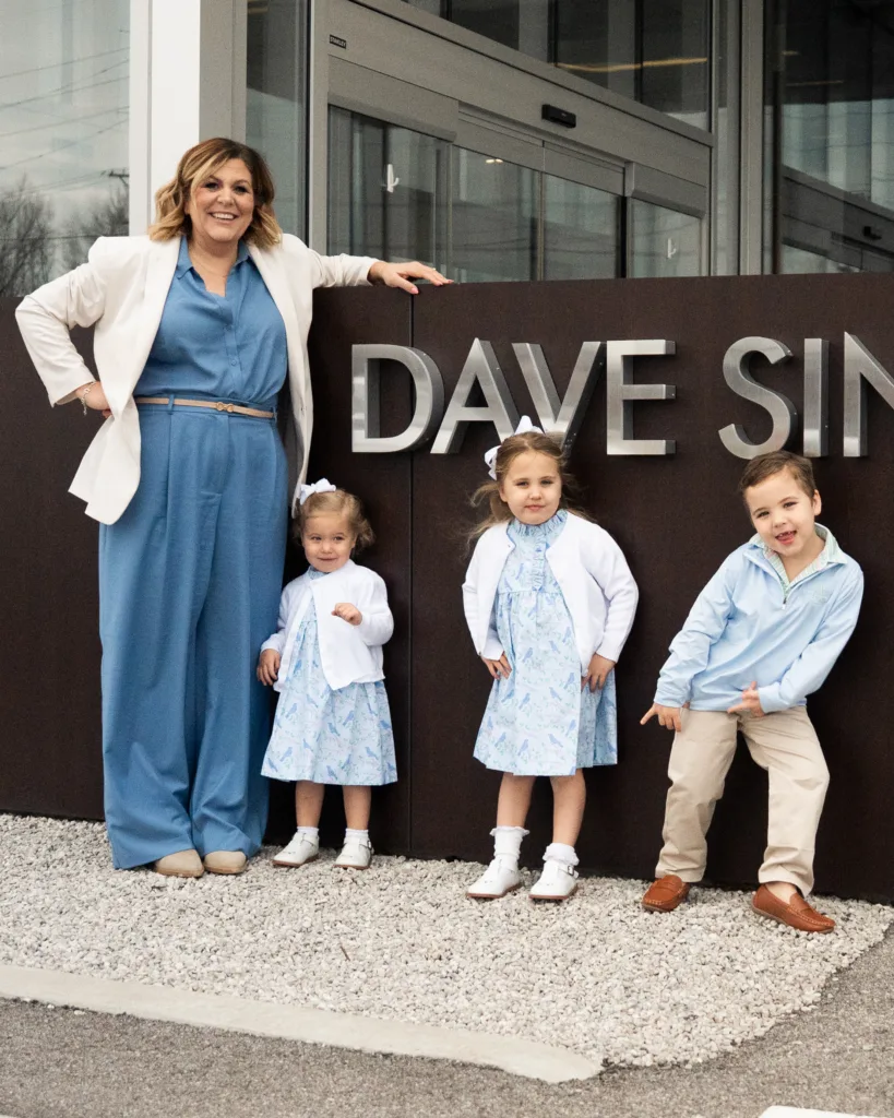 Megan Sinclair and her children pose outside the dealership.