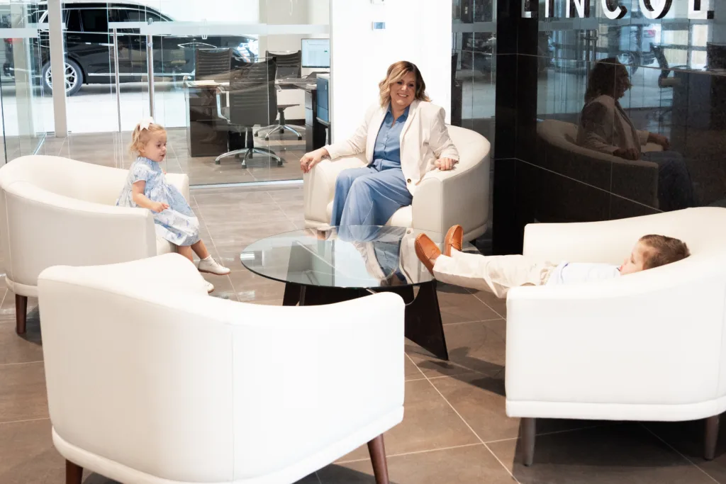 Megan Sinclair shares a relaxed moment with her kids inside the dealership.