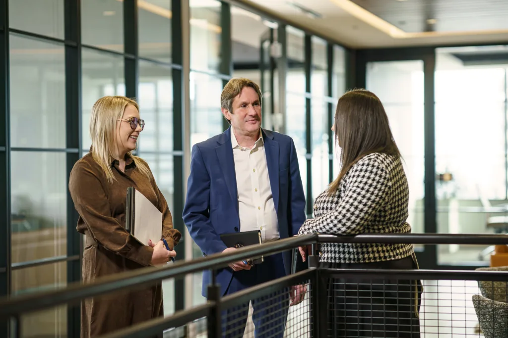 Capes Sokol associate Melissa DeClue, shareholder Michael Schechter, and counsel Ajla Alunovic connect in the office.