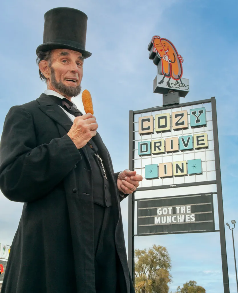 Abraham Lincoln enjoys a classic Cozy Dog outside the iconic Route 66 eatery in Springfield, Illinois.