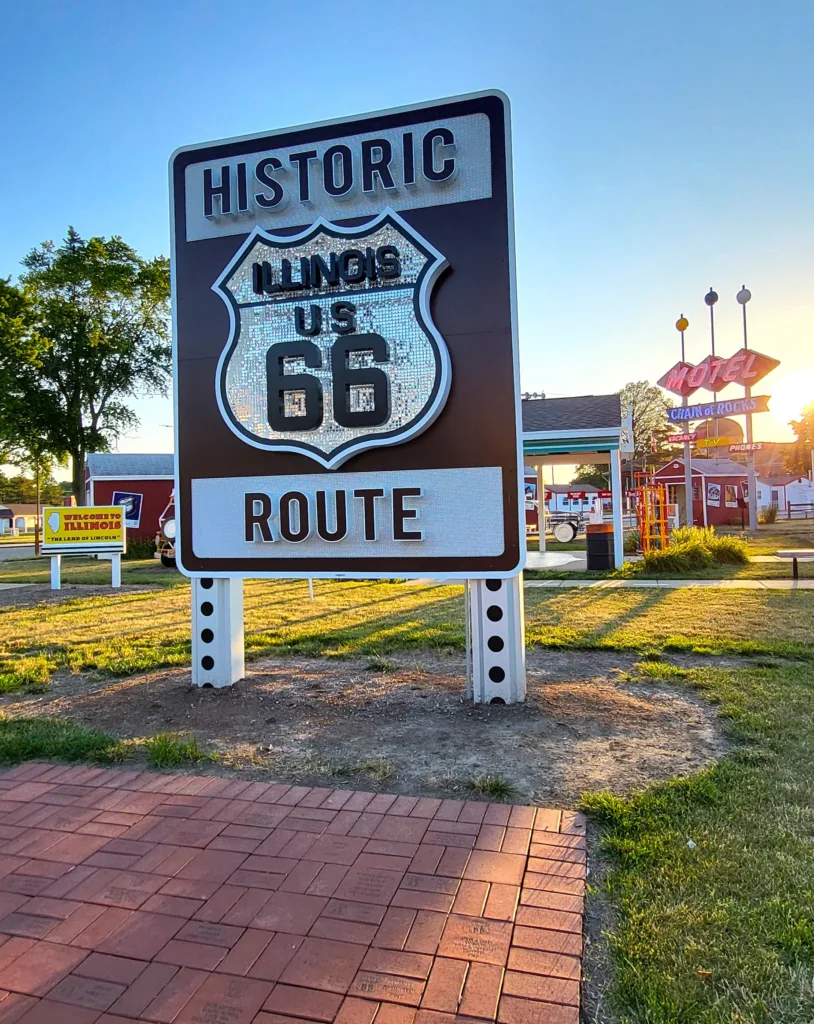 A shimmering Route 66 sign welcomes travelers to historic Illinois.