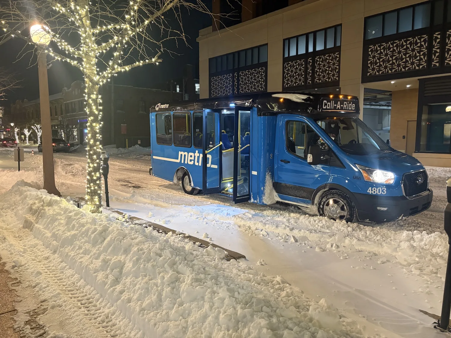 A shuttle parked on a snowy street.