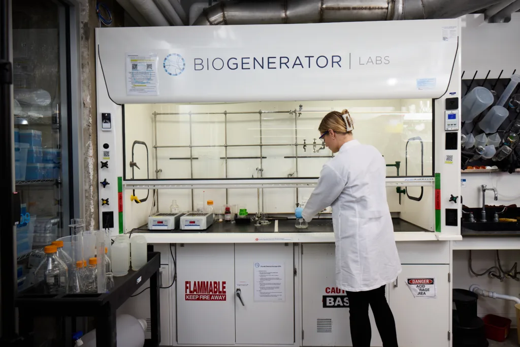 A BioGenerator tenant conducts research in one of the shared lab’s fume hoods. Across its two locations, BioGenerator Labs has supported 200+ tenant companies, while BioGenerator Ventures has invested in 140+ portfolio companies.