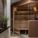 An angled sauna and angled shower were positioned across from each other, organizing the bathroom around a central stone veneer feature wall.