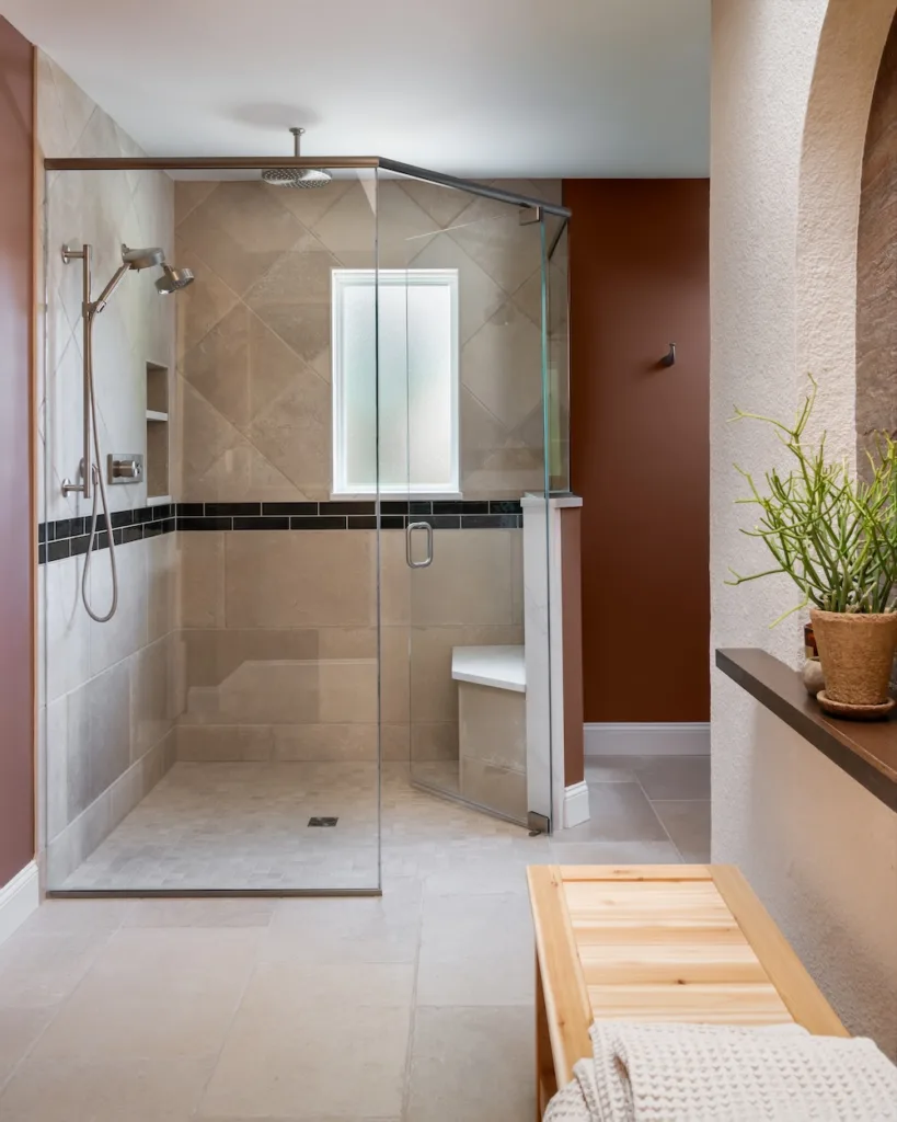 Positioned opposite the sauna, the expanded walk-in shower helps balance the room’s new angled design and open flow.
