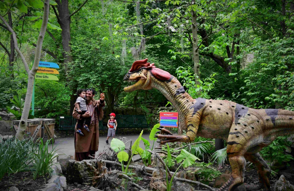 Guests interact with a Dilophosaurus animatronic at Dinoroarus.
