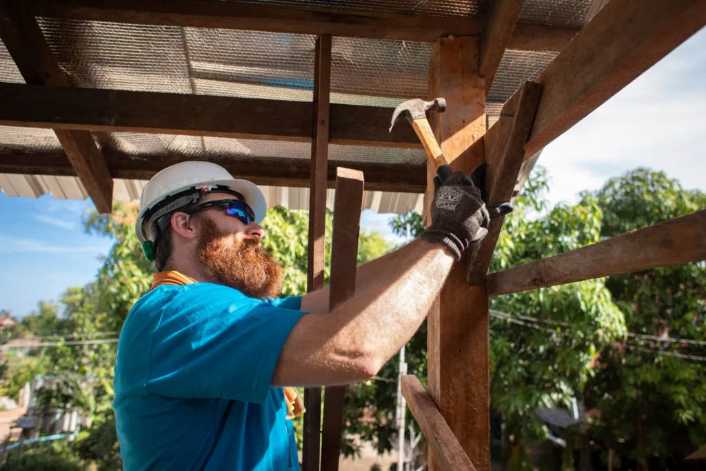 Australian volunteer from Hewlett Packard Enterprise (HPe), Matthew Sutherland, gets instructions from Habitat for Humanity in Cambodia’s team during a construction in Soutr Nikom District in Siem Reap Province.