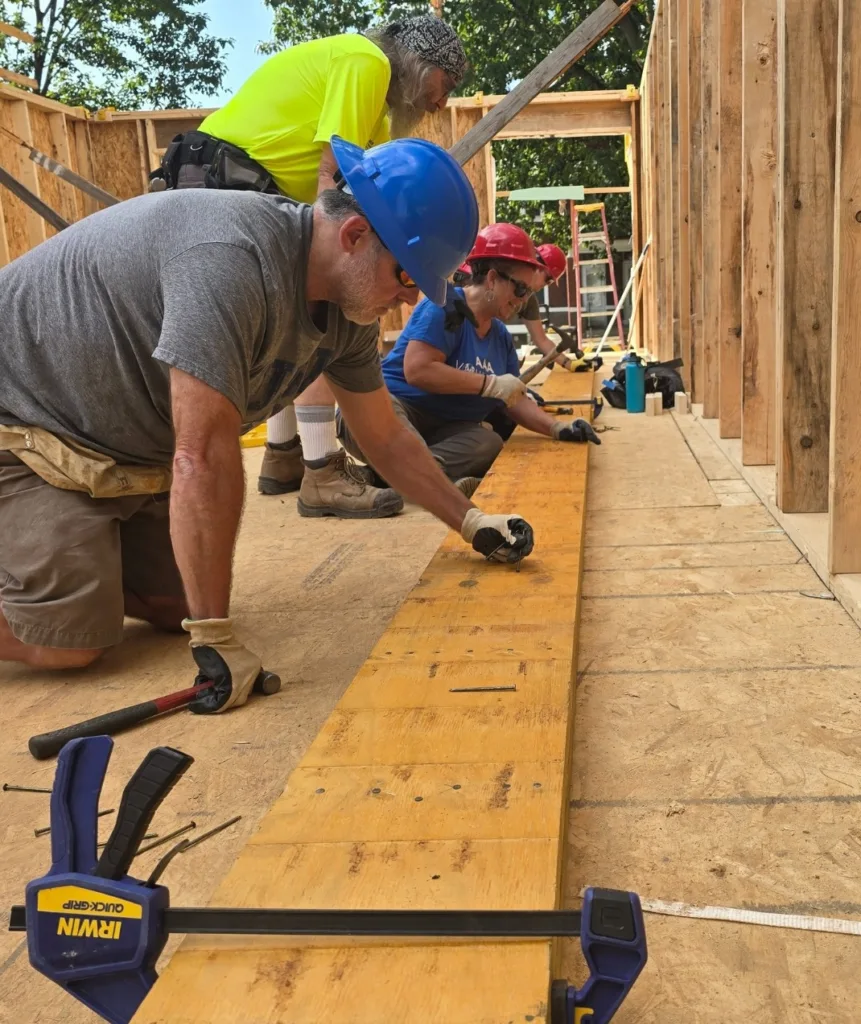 Habitat for Humanity volunteers work together on a home build.